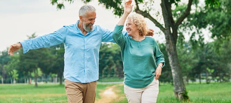 Happy older couple walking outside