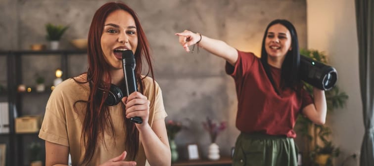 Young women doing karaoke