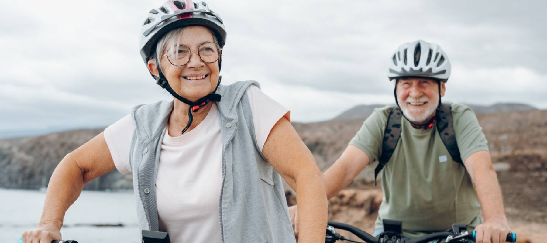 Happy retired couple biking