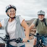Happy retired couple biking