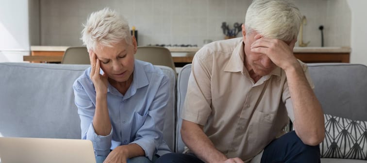 Older couple unhappy while reviewing paperwork