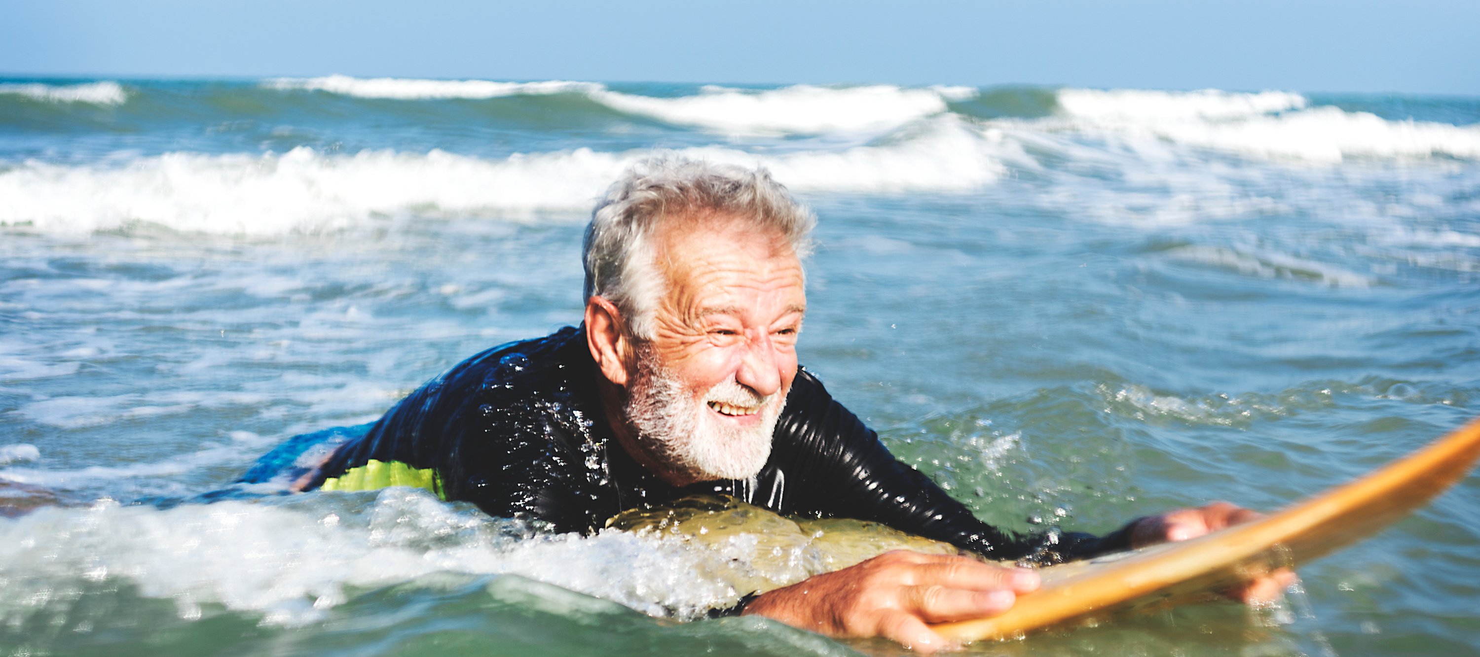 Senior man surfing