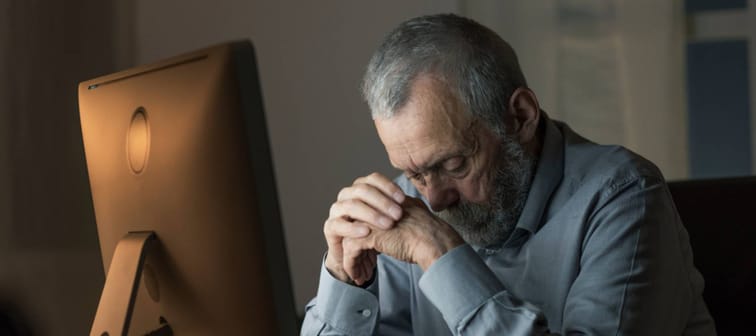 Man depressed on computer