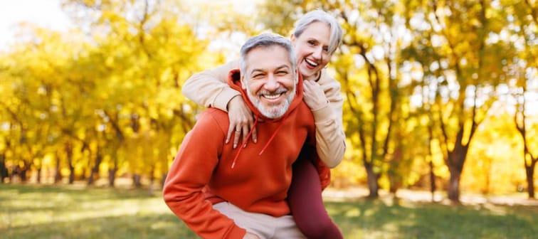 Portrait of lovely happy elderly couple on morning run outside in city park