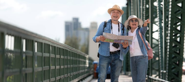 Elderly couples travel on the old iron bridge (Phra Phutthayotfa Bridge) in Bangkok, Thailand
