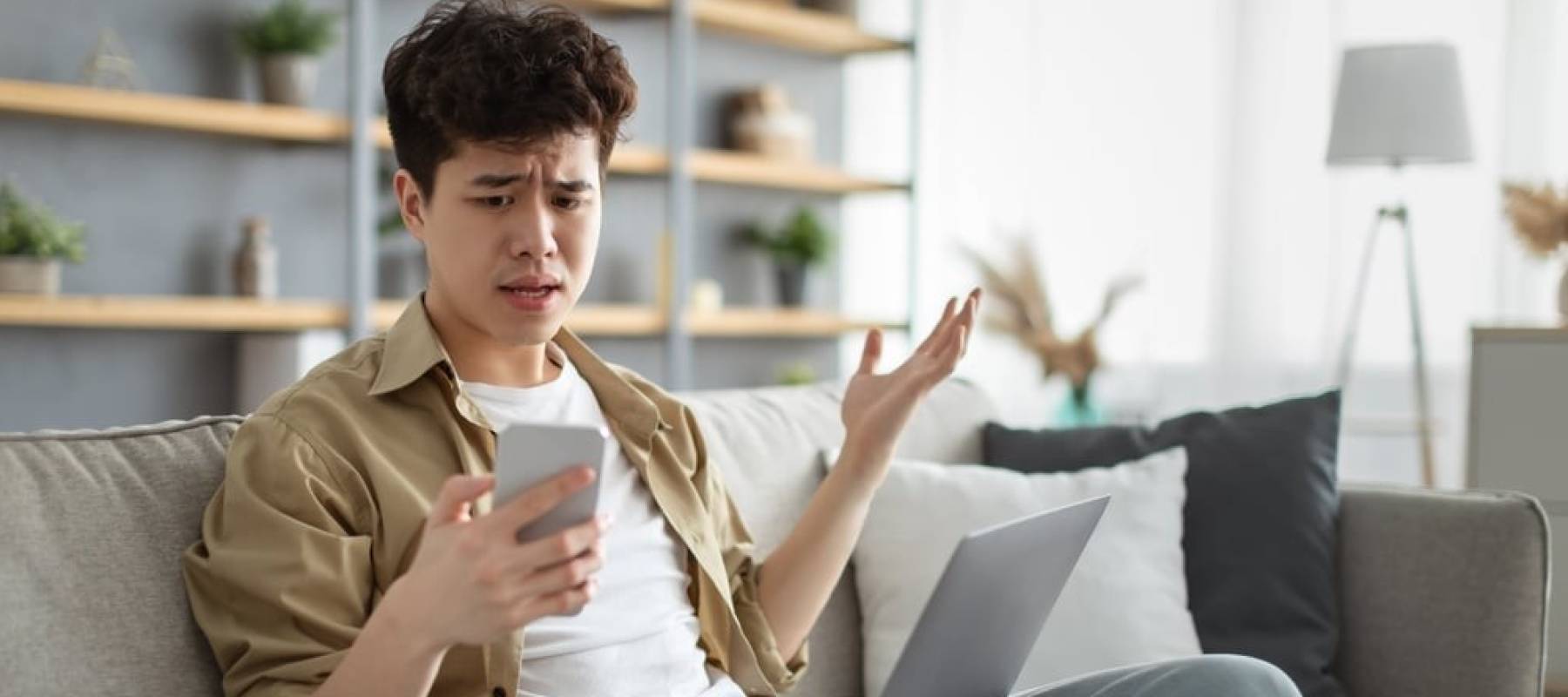 Man looking shocked at his phone