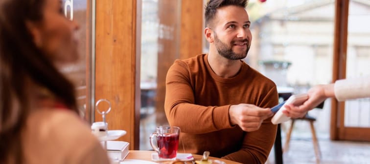 Man paying for dinner at a restaurant